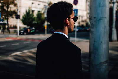 Rear view of man on street in city