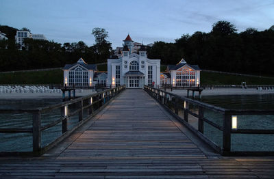 Boardwalk amidst buildings against sky