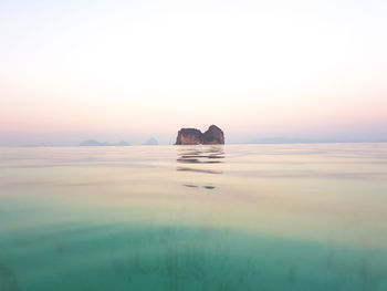 Scenic view of sea against clear sky during sunset