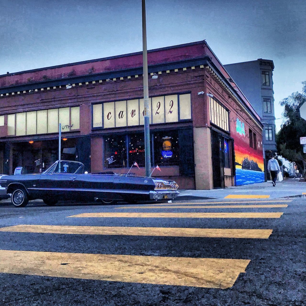 CARS ON ROAD BY BUILDING AGAINST SKY