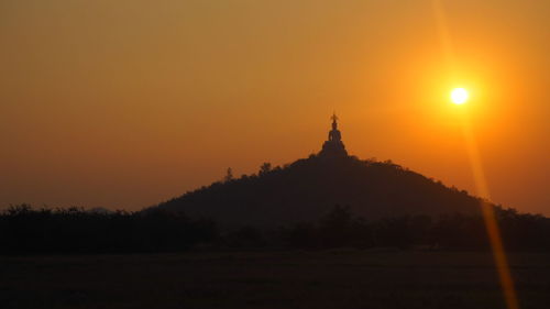 Silhouette temple against clear sky during sunset