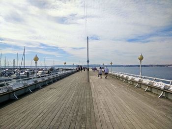 Jetty on beach against sky