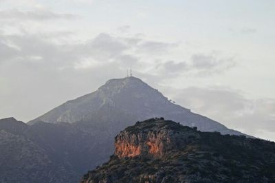 Scenic view of mountains against cloudy sky