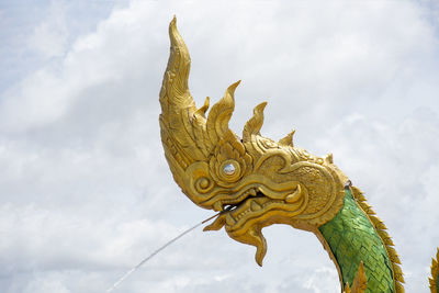 Low angle view of angel statue against sky