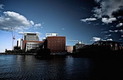 City by river against sky