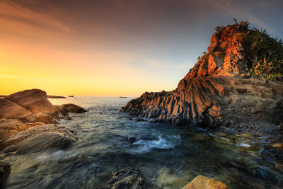 Scenic view of sea against sky at sunset