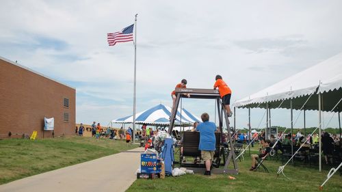 People standing at beach against sky