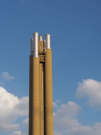 Low angle view of smoke stack against sky