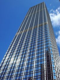 Low angle view of modern building against blue sky