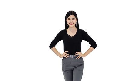 Portrait of a smiling young woman against white background