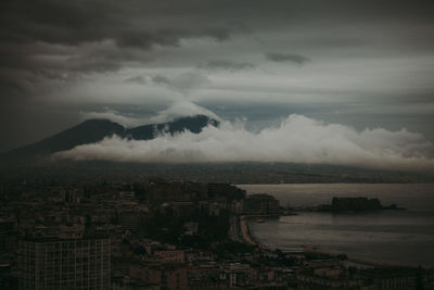 High angle view of cityscape by sea against sky