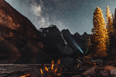 Panoramic view of illuminated tree against sky at night