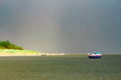 Boats sailing on sea against sky