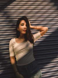 Portrait of beautiful young woman standing outdoors