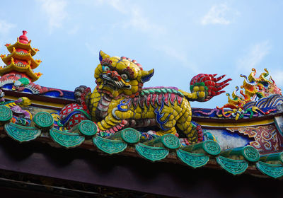 Lion statue on the entrance of a chinese temple in phuket, thailand.