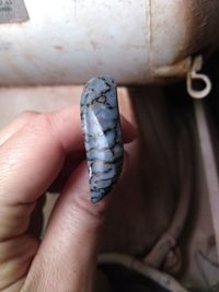 Close-up of hand holding cigarette