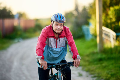 Portrait of young woman riding bicycle