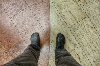 Low section of man standing on sidewalk