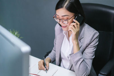 Midsection of woman using mobile phone