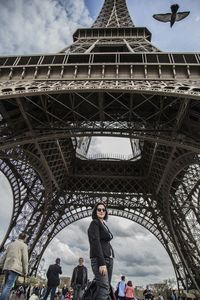 Low angle view of tourists against clear sky