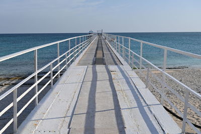 Railway bridge over sea against sky