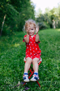 Full length of cute baby girl on grass