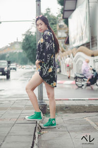 Full length of woman on street in city