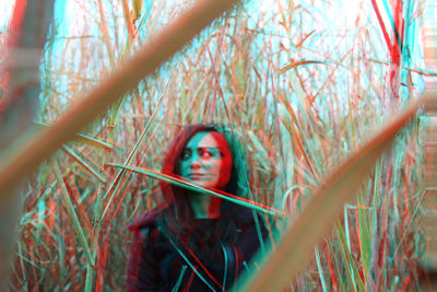 Double exposure of young woman looking away on field