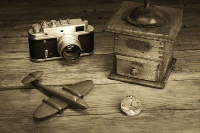 Close-up camera and pocket watch on table