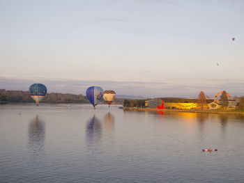 View of hot air balloon flying over lake