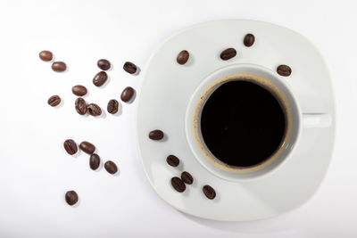 Directly above shot of coffee cup over white background