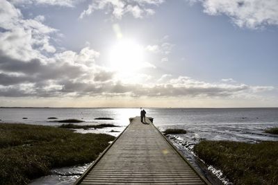 Scenic view of sea against sky and a wooden pier