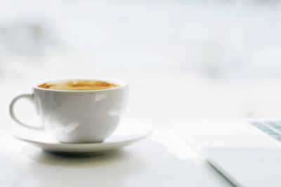 Close-up of coffee cup on table