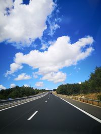 View of highway against cloudy sky