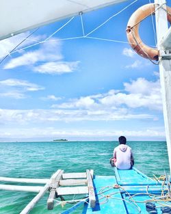 Rear view of man on boat