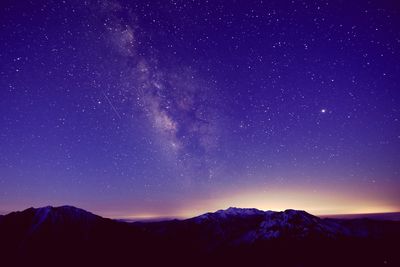 Scenic view of mountains against sky at night