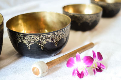 High angle view of singing bowls with flower on table