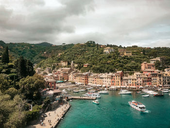 High angle view of townscape by sea against sky