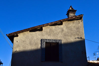 Low angle view of building against blue sky