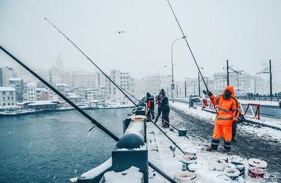 People working in boat against sky