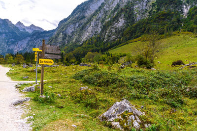 Information sign on landscape against mountains