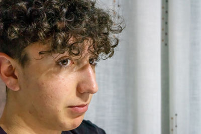 Close-up portrait of teenage girl looking away