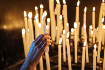 Close-up of hand holding candle