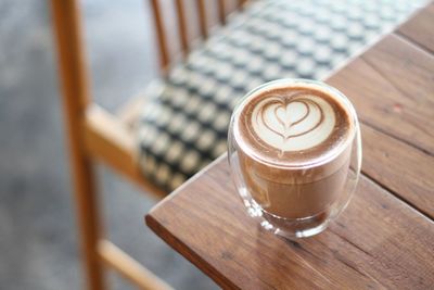 High angle view of hot chocolate served on wooden table