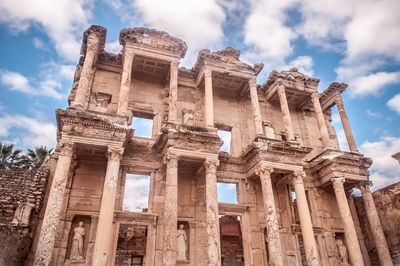 Low angle view of historical building against cloudy sky