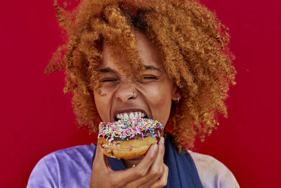 Portrait of woman eating a donut