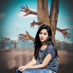 Portrait of a young woman sitting outdoors