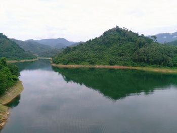 Scenic view of lake and mountains against sky