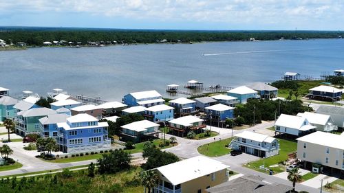 High angle view of buildings and sea against sky