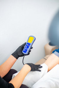 Low section of woman using mobile phone